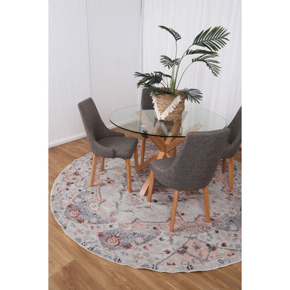 Practical and elegant Sauville Blush Multi Round Rug beneath a dining table, highlighting their stain and water-resistant capabilities thanks to NanoWipe technology